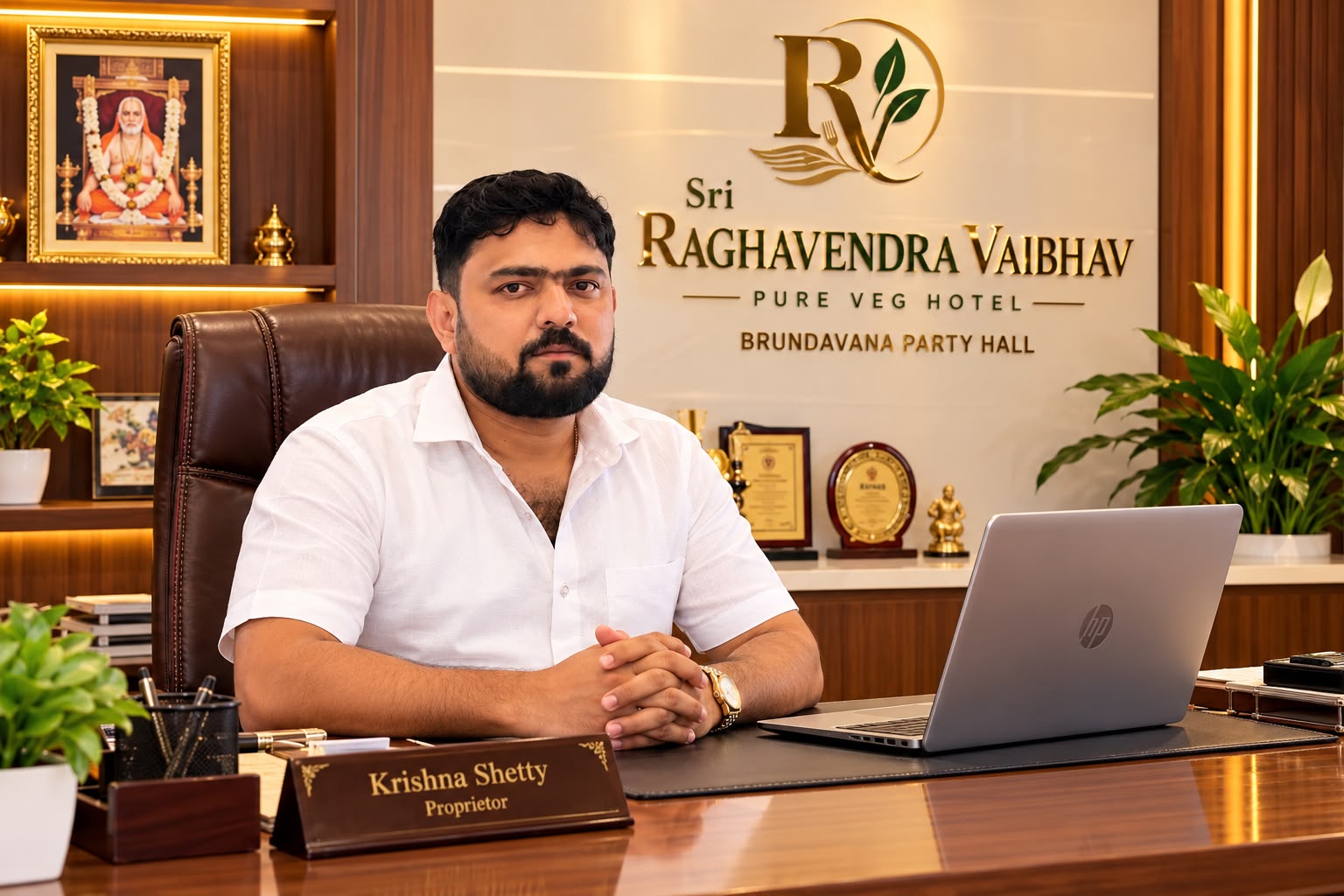Krishna Shetty, proprietor of Sri Raghavendra Vaibhav, seated at his desk